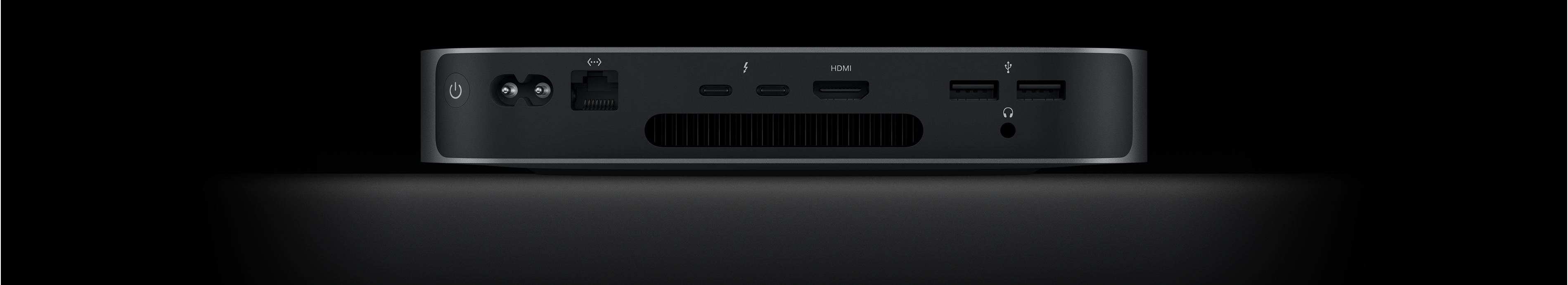Mac minin taustanäkymä, jossa näkyy kaksi Thunderbolt 4 ‑porttia, HDMI-portti, kaksi USB-A-porttia, kuulokeliitäntä, Gigabit Ethernet ‑portti, virtaportti ja virtapainike.